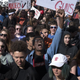 Aaron Durst, 17, a student at East High School in Denver, raises his hand in protest against gun violence on the Colorado State Capitol grounds on March 14, 2018, in Denver.